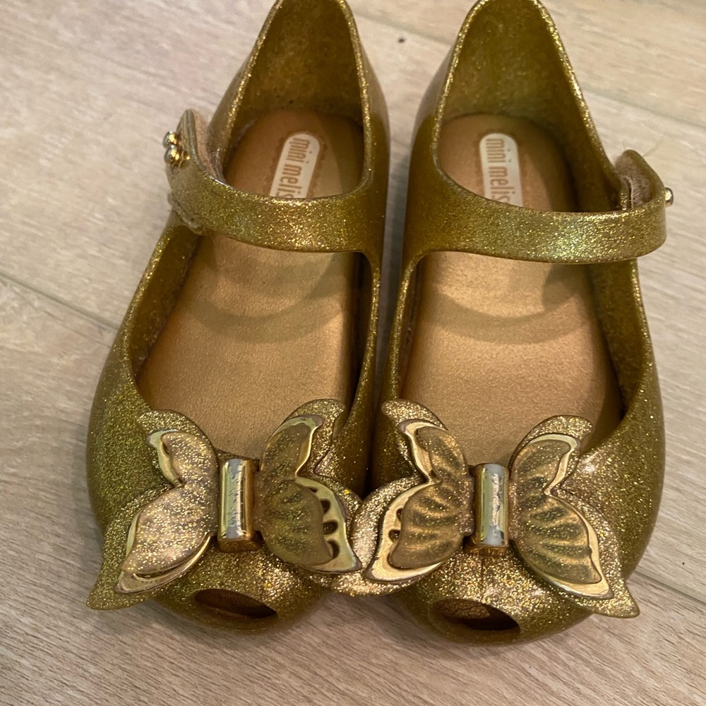 Gold sparkle butterfly Mini Melissa 7T shoes. Some wear but great condition.